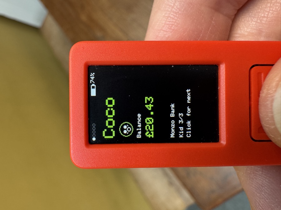 Close-up of the M5Stick showing Coco's balance of £20.43 with a small emoji icon